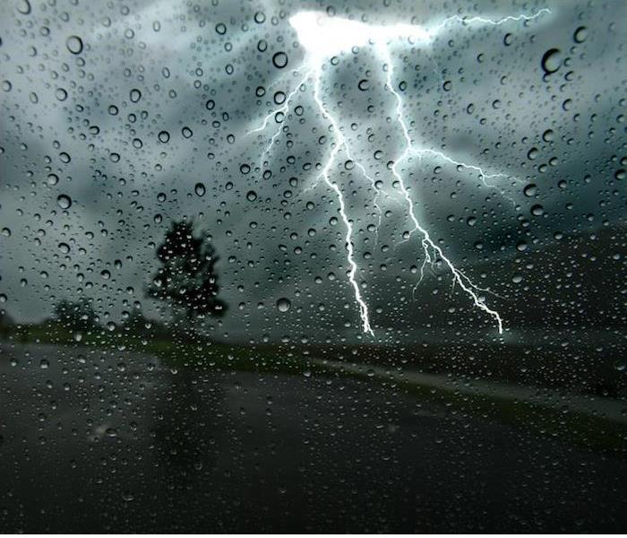 lightening striking in front of a car 