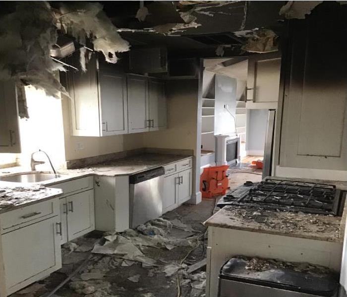 kitchen covered with debris from fire